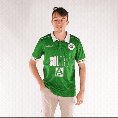 A Man Wearing A Green Solary Shirt Stands With His Eyes Closed GIF