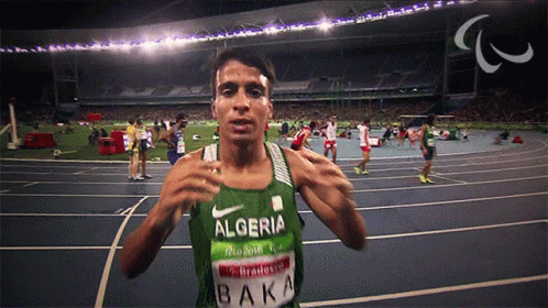 A Man Wearing A Green Tank Top That Says Algeria Baka GIF