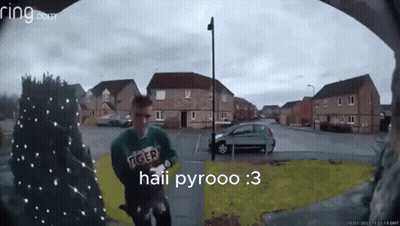 A Man Wearing A Green Tiger Sweatshirt Is Standing In Front Of A Ring Doorbell GIF