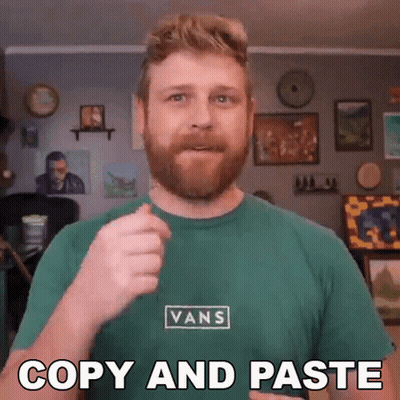A Man Wearing A Green Vans Shirt Is Giving A Thumbs Up GIF