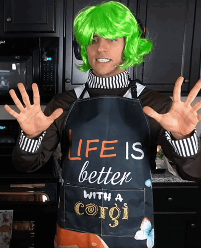 A Man Wearing A Green Wig And An Apron That Says " Life Is Better With A Corgi " GIF