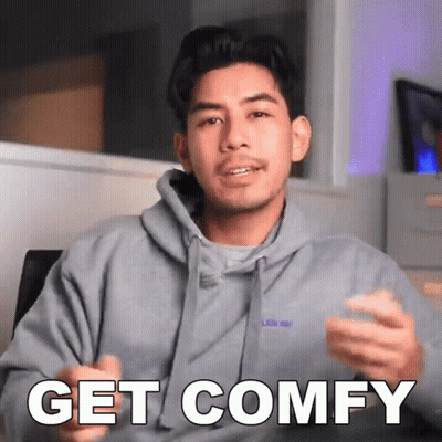 A Man Wearing A Grey Hoodie Says " Get Comfy " GIF