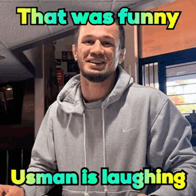A Man Wearing A Grey Nike Hoodie Is Laughing With A Caption That Says That Was Funny Usman Is Laughing GIF