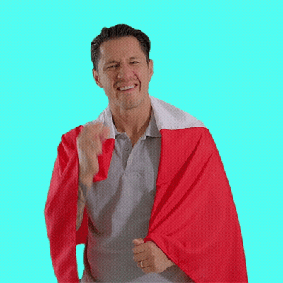 A Man Wearing A Grey Shirt And A Red And White Cape GIF