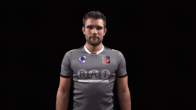 A Man Wearing A Grey Shirt That Says Bat GIF