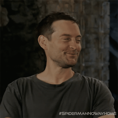 A Man Wearing A Grey Shirt With #Spidermannowaway Home Written On The Bottom GIF