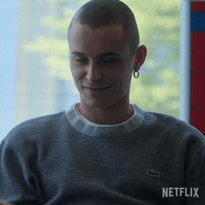 A Man Wearing A Grey Sweater With A White Lacoste Logo GIF
