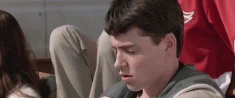 A Man Wearing A Grey Sweatshirt With The Letter A On The Front GIF