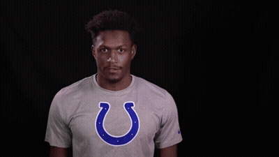 A Man Wearing A Grey T-Shirt With A Horseshoe On It GIF
