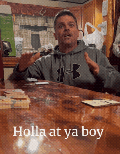 A Man Wearing A Grey Under Armour Sweatshirt Sitting At A Table GIF