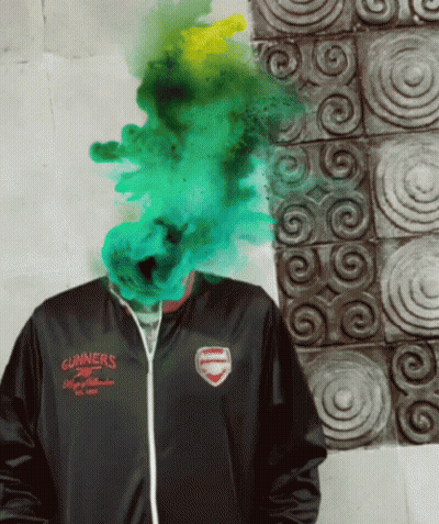 A Man Wearing A Gunners Jacket Has Green Smoke Coming Out Of His Face GIF