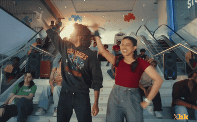 A Man Wearing A Guns N ' Roses Shirt Is Standing Next To A Girl GIF