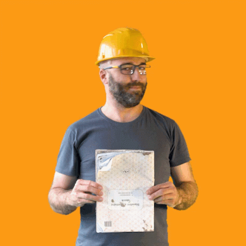 A Man Wearing A Hard Hat And Glasses Is Holding A Piece Of Paper That Says " Swedish Airways " GIF