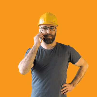 A Man Wearing A Hard Hat And Glasses Talking On A Cell Phone GIF