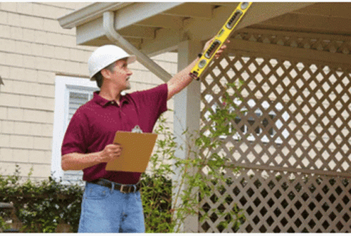 A Man Wearing A Hard Hat Is Holding A Level That Says ' Stanley ' On It GIF