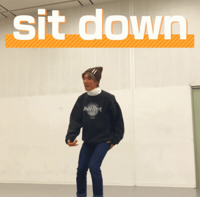 A Man Wearing A Hard Rock Cafe Sweatshirt Is Squatting GIF