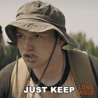 A Man Wearing A Hat And A Backpack Says " Just Keep " GIF