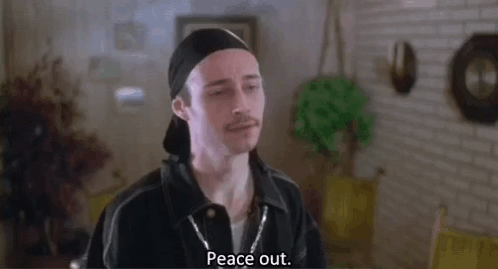 A Man Wearing A Hat And A Bandana Is Standing In A Living Room And Saying Peace Out . GIF
