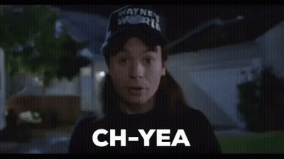 A Man Wearing A Hat And A Black Shirt Is Standing In Front Of A House And Saying `` Ch-Yea '' . GIF