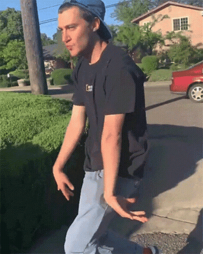 A Man Wearing A Hat And A Black Shirt With The Letter L On The Front GIF