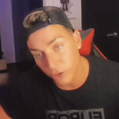 A Man Wearing A Hat And A Black Shirt With The Word Rogue On It GIF