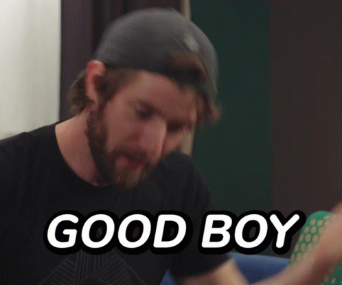 A Man Wearing A Hat And A Black Shirt With The Words Good Boy Below Him GIF