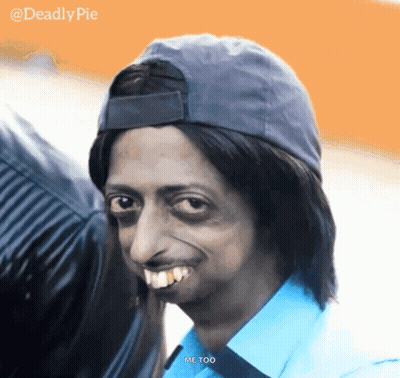 A Man Wearing A Hat And A Blue Shirt Is Smiling And Says Me Too GIF