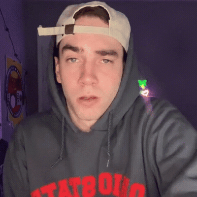 A Man Wearing A Hat And A Hoodie That Says Tat80 On It GIF