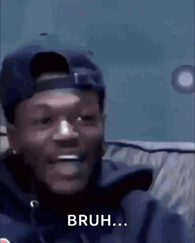 A Man Wearing A Hat And A Jacket Is Smiling And Says Bruh . GIF
