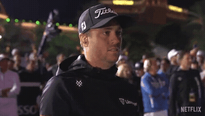 A Man Wearing A Hat And A Jacket Is Standing In Front Of A Crowd Of People . GIF