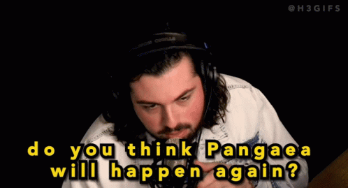 A Man Wearing A Hat And A Jacket Is Talking Into A Microphone GIF