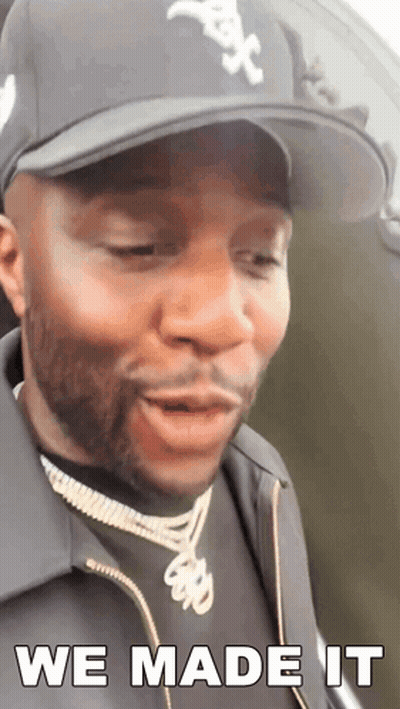 A Man Wearing A Hat And A Jacket Says We Made It GIF