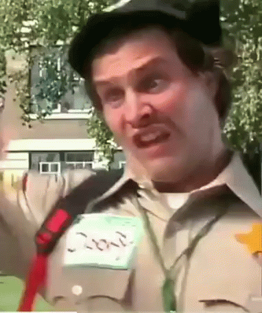 A Man Wearing A Hat And A Name Tag That Says Ron GIF