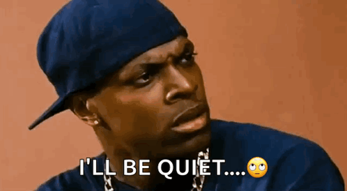 A Man Wearing A Hat And A Necklace Is Saying `` I 'Ll Be Quiet ... '' . GIF
