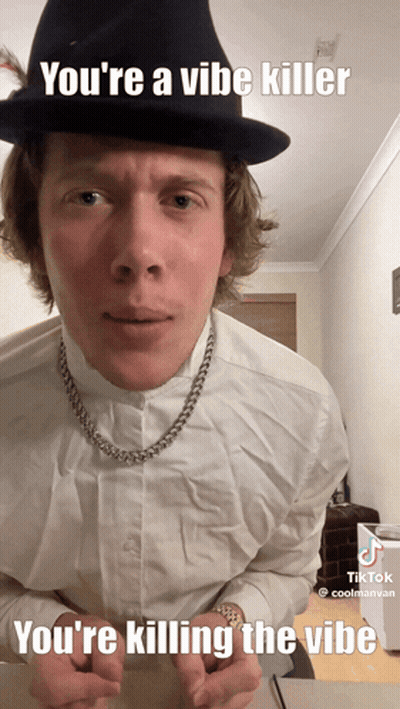 A Man Wearing A Hat And A Necklace Says You 'Re A Vibe Killer You 'Re Killing The Vibe GIF