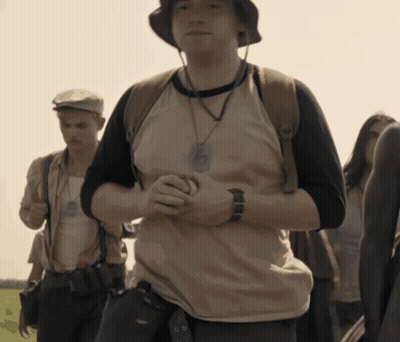 A Man Wearing A Hat And A Necklace With A Badge That Says ' Army ' On It GIF