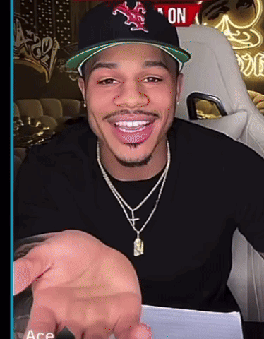 a man wearing a hat and a necklace with the word ace on the bottom right