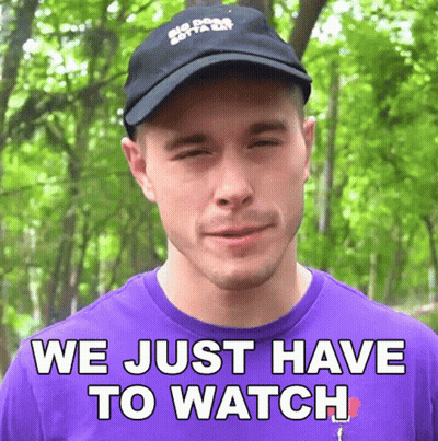 A Man Wearing A Hat And A Purple Shirt Says " We Just Have To Watch " GIF