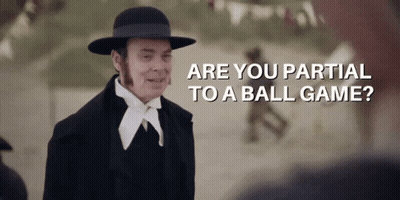 A Man Wearing A Hat And A Suit Says " Are You Partial To A Ball Game " GIF