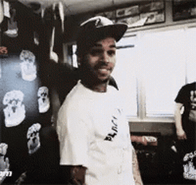 A Man Wearing A Hat And A T-Shirt That Says " Black " On It GIF