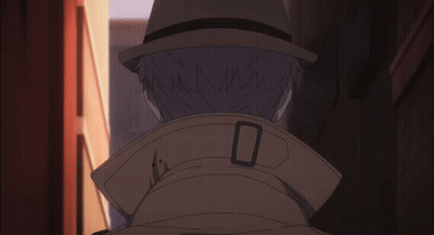 A Man Wearing A Hat And A Trench Coat Has The Letter O On The Collar GIF
