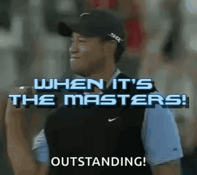 A Man Wearing A Hat And A Vest Is Standing In Front Of A Crowd And Holding A Microphone . GIF