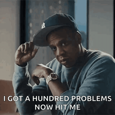 A Man Wearing A Hat And A Watch Is Saying I Got A Hundred Problems Now Hit Me GIF