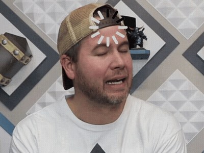 A Man Wearing A Hat And A White Shirt Has A Light Coming Out Of His Head GIF