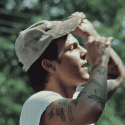 A Man Wearing A Hat And A White Tank Top Has A Tattoo On His Arm That Says ' I Love You ' GIF