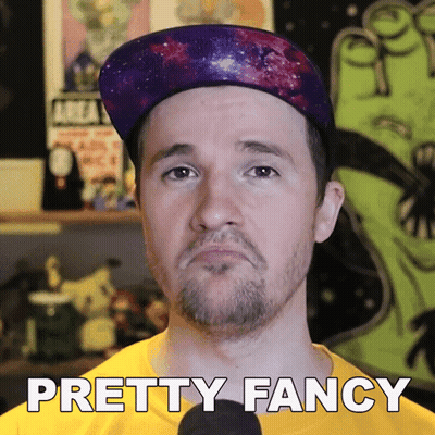 A Man Wearing A Hat And A Yellow Shirt With The Words Pretty Fancy Below Him GIF