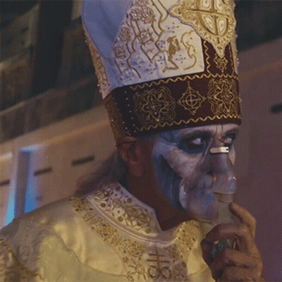 A Man Wearing A Hat And An Oxygen Mask On His Nose GIF