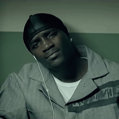 A Man Wearing A Hat And Ear Buds Is Listening To A Song GIF