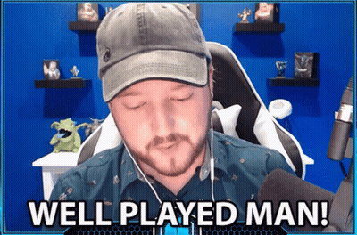 A Man Wearing A Hat And Ear Buds Is Sitting In Front Of A Microphone And Says Well Played Man GIF