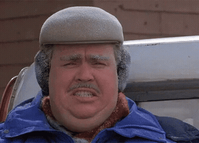 A Man Wearing A Hat And Ear Muffs Is Making A Face GIF
